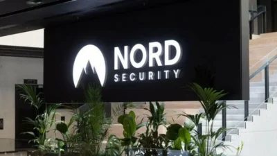 Nord Security logo on the modern reception desk with surrounding greenery and staircase in the background.